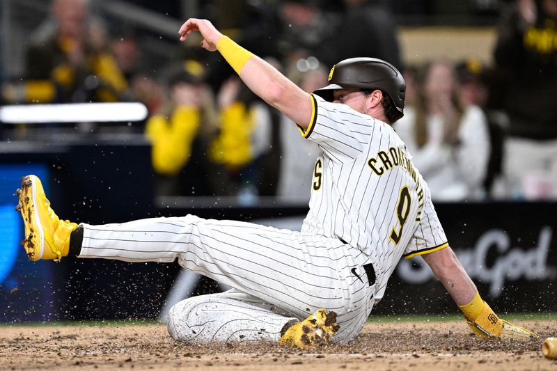 Apr 30, 2024; San Diego, California, USA; San Diego Padres first baseman Jake Cronenworth (9) slides home to score a run on a three-RBI double hit by designated hitter Manny Machado (not pictured) during the fifth inning against the Cincinnati Reds at Petco Park. Mandatory Credit: Orlando Ramirez-USA TODAY Sports