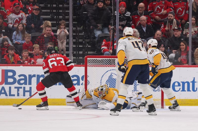 Jan 29, 2026; Newark, New Jersey, USA; New Jersey Devils left wing Jesper Bratt (63) scores a goal on Nashville Predators goaltender Justus Annunen (29) during the third period at Prudential Center. Mandatory Credit: Ed Mulholland-Imagn Images