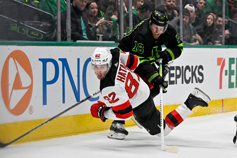 Mar 14, 2024; Dallas, Texas, USA; New Jersey Devils defenseman Santeri Hatakka (82) falls to the ice in front of Dallas Stars center Joe Pavelski (16) during the second period at the American Airlines Center. Mandatory Credit: Jerome Miron-USA TODAY Sports