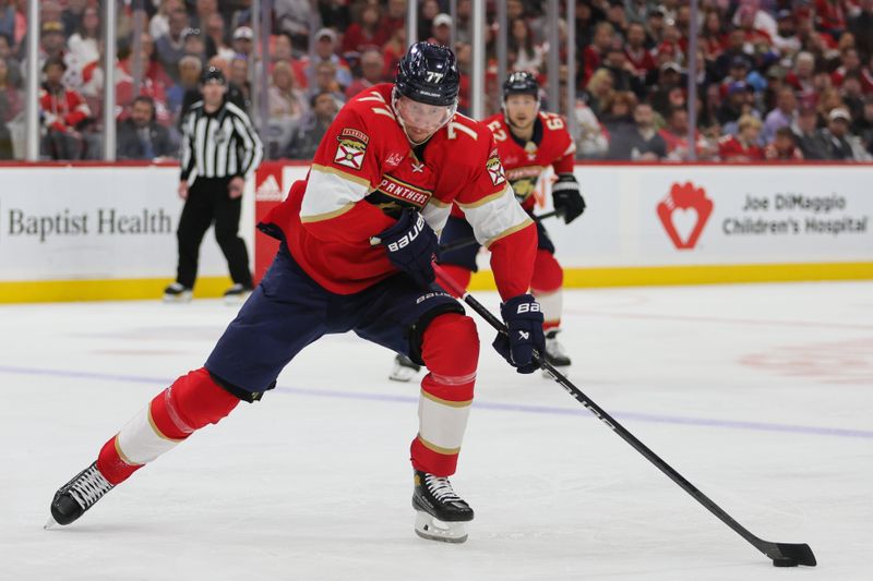 Feb 29, 2024; Sunrise, Florida, USA; Florida Panthers defenseman Niko Mikkola (77) moves the puck against the Montreal Canadiens during the second period at Amerant Bank Arena. Mandatory Credit: Sam Navarro-USA TODAY Sports