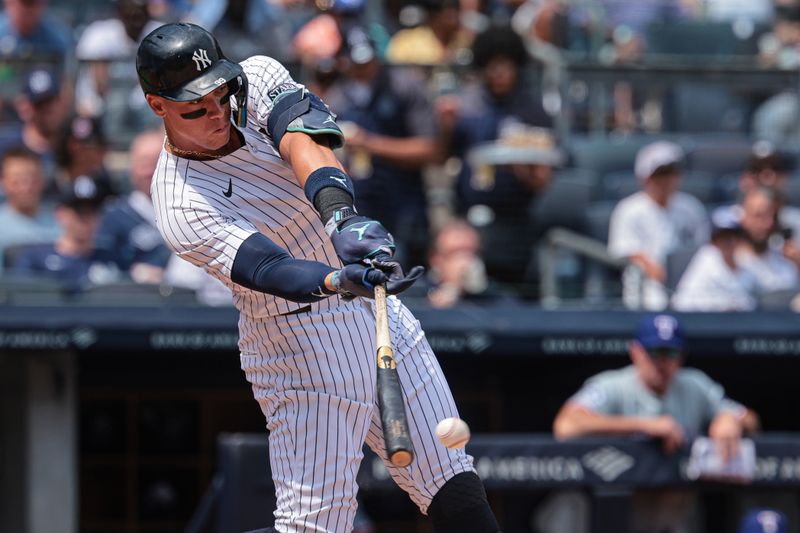 Aug 11, 2024; Bronx, New York, USA; New York Yankees center fielder Aaron Judge (99) singles during the first inning against the Texas Rangers at Yankee Stadium. Mandatory Credit: Vincent Carchietta-USA TODAY Sports