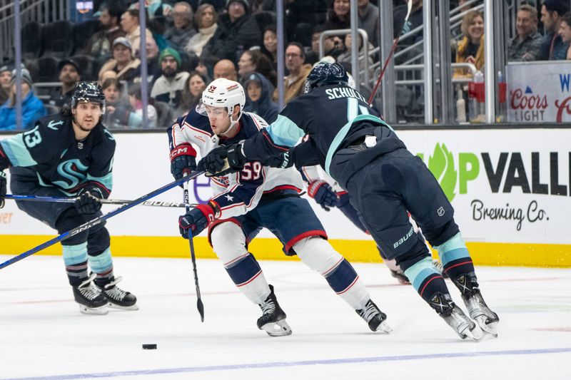 Jan 28, 2024; Seattle, Washington, USA; Columbus Blue Jackets forward Yegor Chinakhov (59) skates against Seattle Kraken defenseman Justin Schultz (4) during the first period at Climate Pledge Arena. Mandatory Credit: Stephen Brashear-USA TODAY Sports