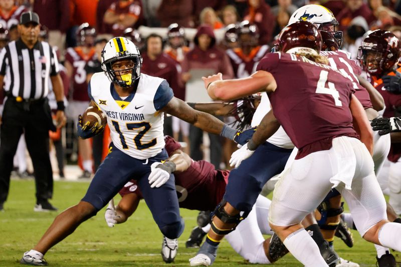 Sep 22, 2022; Blacksburg, Virginia, USA; Virginia Tech Hokies defensive lineman TyJuan Garbutt (45) grabs West Virginia Mountaineers tight end CJ Donaldson (12) as Hokies linebacker Dax Hollifield (4) and defensive lineman Jaylen Griffin (41) close in during the second half at Lane Stadium. Mandatory Credit: Reinhold Matay-USA TODAY Sports