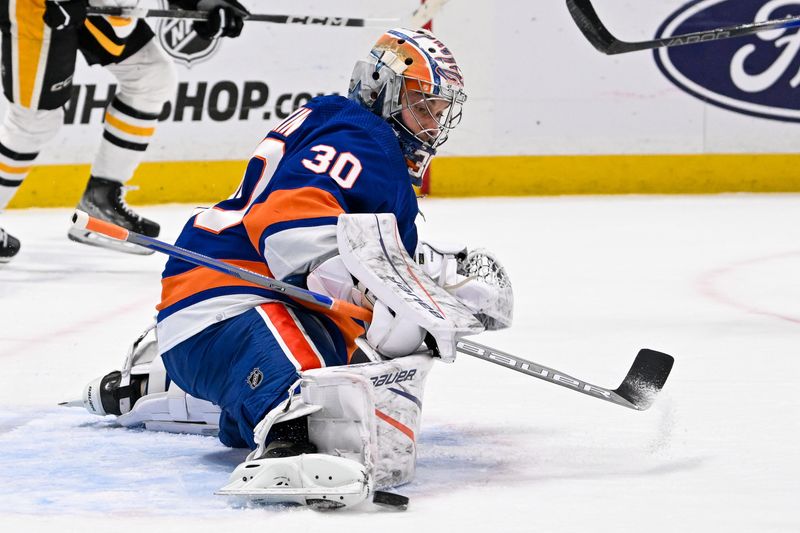 Apr 17, 2024; Elmont, New York, USA;  New York Islanders goaltender Ilya Sorokin (30) makes a save against the Pittsburgh Penguins during the first period at UBS Arena. Mandatory Credit: Dennis Schneidler-USA TODAY Sports