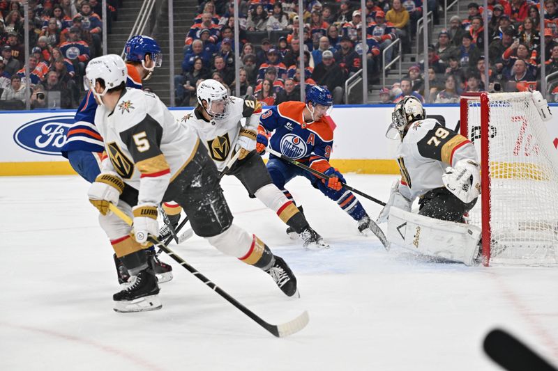 Dec 21, 2025; Edmonton, Alberta, CAN; Vegas Golden Knights defenseman Zach Whitecloud (2) battles with Edmonton OIlers center Ryan Ngent-Hopkins (93) in front of Vegas Golden Knights goalie Carter Hart (79) during the first period at Rogers Place. Mandatory Credit: Walter Tychnowicz-Imagn Images