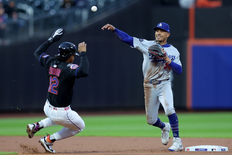 May 23, 2025; New York City, New York, USA; Los Angeles Dodgers shortstop Mookie Betts (50) forces out New York Mets shortstop Francisco Lindor (12) at second base then throws to first to complete a double play on a ball hit by Mets right fielder Juan Soto (not pictured) during the first inning at Citi Field. Mandatory Credit: Brad Penner-Imagn Images