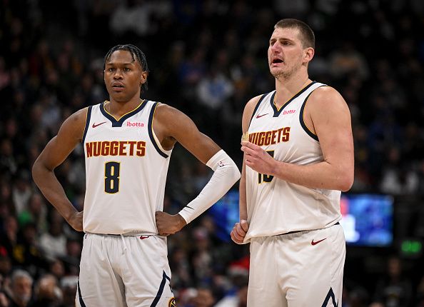 DENVER, CO - DECEMBER 25: Nikola Jokic (15) of the Denver Nuggets and Peyton Watson (8) stand at midcoast during the third quarter against the Golden State Warriors at Ball Arena in Denver on Monday, December 25, 2023. (Photo by AAron Ontiveroz/The Denver Post)