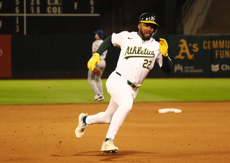 Jun 19, 2024; Oakland, California, USA; Oakland Athletics left fielder Miguel Andujar (22) rounds third base for a run against the Kansas City Royals during the seventh inning at Oakland-Alameda County Coliseum. Mandatory Credit: Kelley L Cox-USA TODAY Sports
