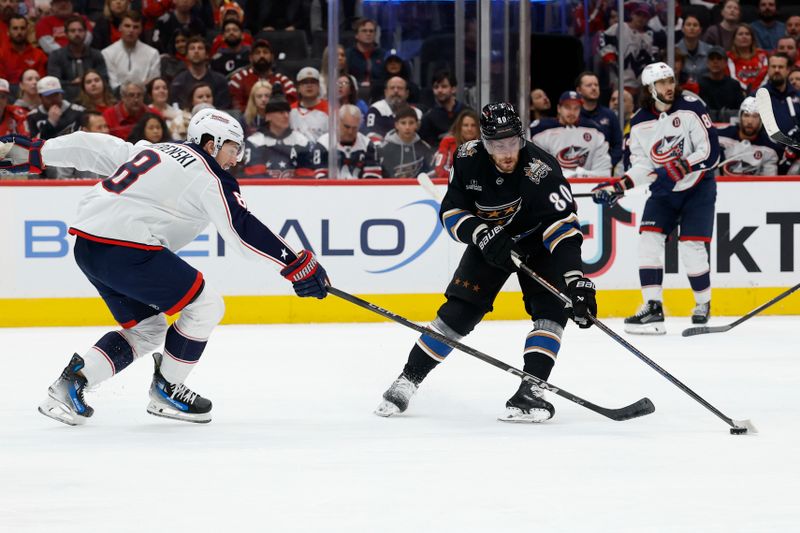 Apr 13, 2025; Washington, District of Columbia, USA; Washington Capitals left wing Pierre-Luc Dubois (80) skates with the puck as Columbus Blue Jackets defenseman Zach Werenski (8) defends in the first period at Capital One Arena. Mandatory Credit: Geoff Burke-Imagn Images