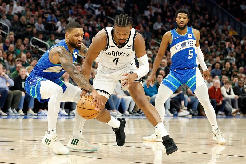 MILWAUKEE, WISCONSIN - MARCH 21: Damian Lillard #0 of the Milwaukee Bucks steals the dribble from Dennis Smith Jr. #4 of the Brooklyn Nets during the second half of the game at Fiserv Forum on March 21, 2024 in Milwaukee, Wisconsin. NOTE TO USER: User expressly acknowledges and agrees that, by downloading and or using this photograph, User is consenting to the terms and conditions of the Getty Images License Agreement. (Photo by John Fisher/Getty Images)