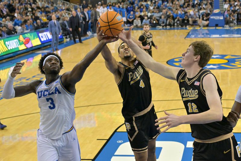 Jan 20, 2026; Los Angeles, California, USA; UCLA Bruins guard Eric Dailey Jr. (3), Purdue Boilermakers forward Trey Kaufman-Renn (4) and center Daniel Jacobsen (12) reach for a rebound in the second half at Pauley Pavilion presented by Wescom Financial. Mandatory Credit: Jayne Kamin-Oncea-Imagn Images