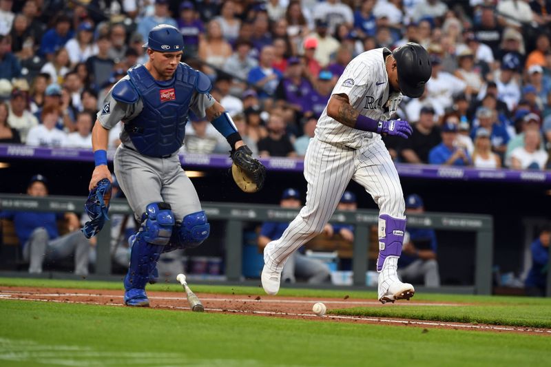 Jun 25, 2025; Denver, Colorado, USA; Colorado Rockies shortstop Orlando Arcia (11) runs as Los Angeles Dodgers catcher Dalton Rushing (68) fields a ball during the third inning at Coors Field. Mandatory Credit: Christopher Hanewinckel-Imagn Images