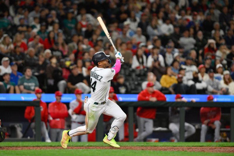 Sep 11, 2023; Seattle, Washington, USA; Seattle Mariners center fielder Julio Rodriguez (44) hits a two-run home run against the Los Angeles Angels during the tenth inning at T-Mobile Park. Mandatory Credit: Steven Bisig-USA TODAY Sports