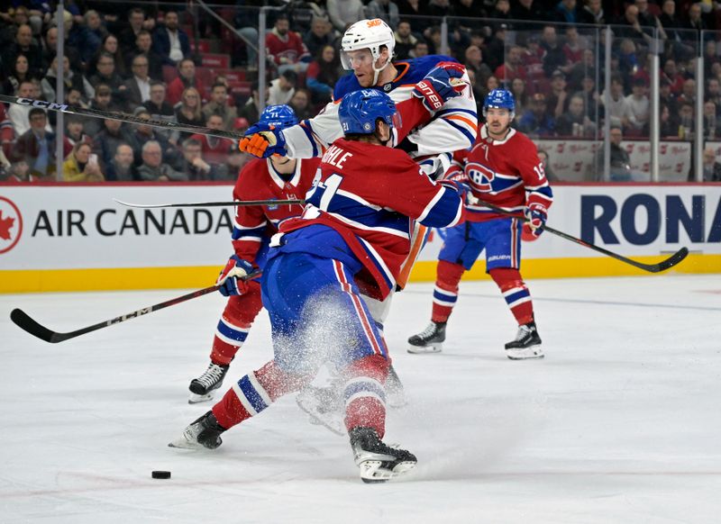 Nov 18, 2024; Montreal, Quebec, CAN; Montreal Canadiens defenseman Kaiden Guhle (21) stops Edmonton Oilers forward Connor McDavid (97) during the first period at the Bell Centre. Mandatory Credit: Eric Bolte-Imagn Images