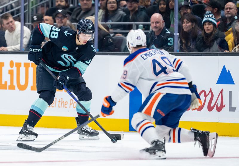 Oct 25, 2025; Seattle, Washington, USA; Seattle Kraken forward Jani Nyman (38) skates against Edmonton Oilers defenseman Ty Emberson (49) during the second period at Climate Pledge Arena. Mandatory Credit: Stephen Brashear-Imagn Images
