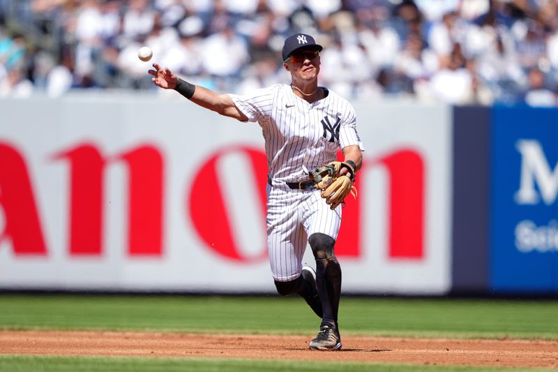 Apr 22, 2024; Bronx, New York, USA; New York Yankees shortstop Anthony Volpe (11) throws to retire Oakland Athletics second baseman Zack Gelof (not pictured) after fielding a ground ball during the fifth inning at Yankee Stadium. Mandatory Credit: Gregory Fisher-USA TODAY Sports