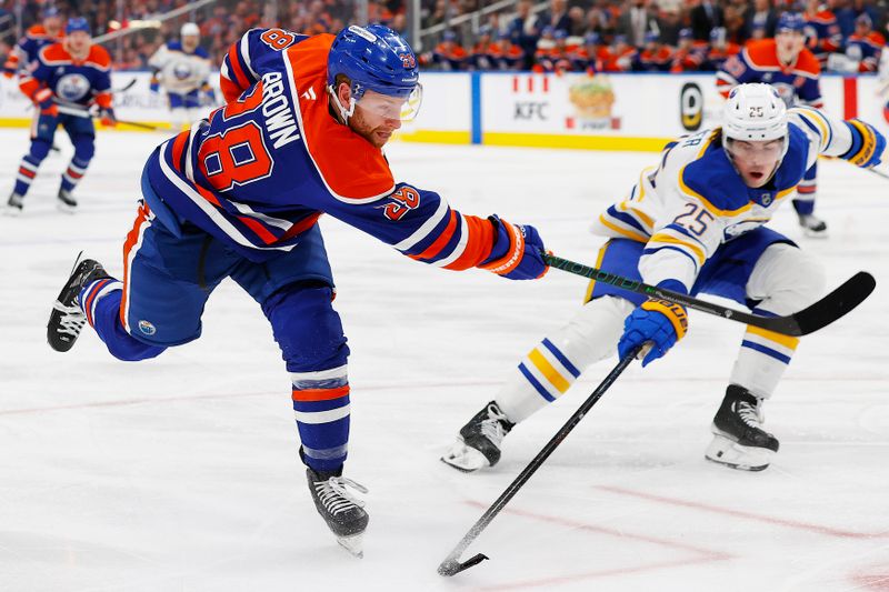 Jan 25, 2025; Edmonton, Alberta, CAN; Edmonton Oilers forward Connor Brown (28) gets a shot away in front of Buffalo Sabres defensemen Owen Power (25) during the third period  at Rogers Place. Mandatory Credit: Perry Nelson-Imagn Images