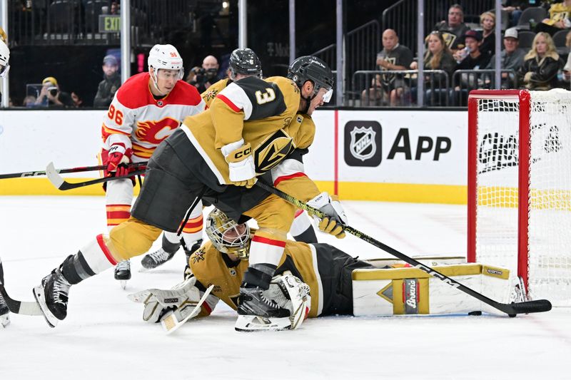 Oct 28, 2024; Las Vegas, Nevada, USA; Vegas Golden Knights goaltender Adin Hill (33) stops a shot near Vegas Golden Knights goaltender Adin Hill (33) against the Calgary Flames in the third period at T-Mobile Arena. Mandatory Credit: Candice Ward-Imagn Images