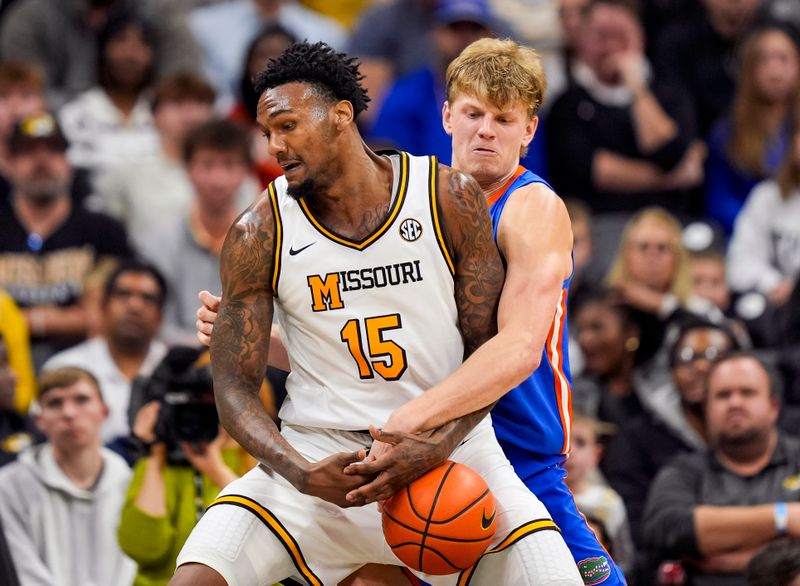 Jan 3, 2026; Columbia, Missouri, USA; Missouri Tigers center Shawn Phillips Jr. (15) drives against Florida Gators forward Thomas Haugh (10) during the second half at Mizzou Arena. Mandatory Credit: Jay Biggerstaff-Imagn Images