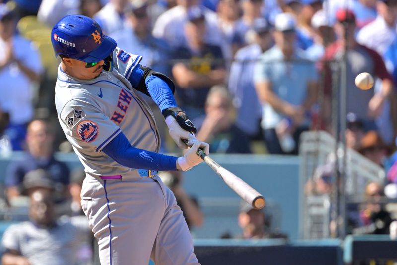 Oct 14, 2024; Los Angeles, California, USA; New York Mets third baseman Mark Vientos (27) hits a grand slam home run in the second inning against the Los Angeles Dodgers during game two of the NLCS for the 2024 MLB Playoffs at Dodger Stadium. Mandatory Credit: Jayne Kamin-Oncea-Imagn Images