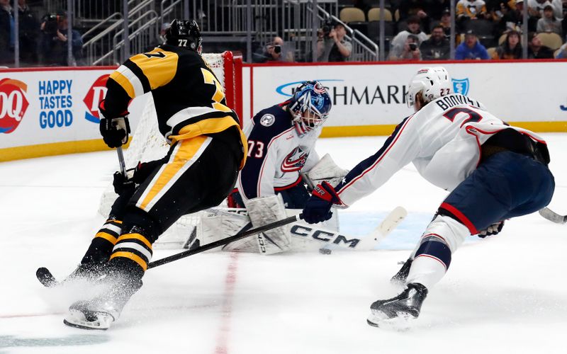 Mar 5, 2024; Pittsburgh, Pennsylvania, USA; Columbus Blue Jackets goaltender Jet Greaves (73)  makes a save against Pittsburgh Penguins center Jeff Carter (77) as defenseman Adam Boqvist (27) defends during the third period at PPG Paints Arena. The Penguins won 5-3. Mandatory Credit: Charles LeClaire-USA TODAY Sports