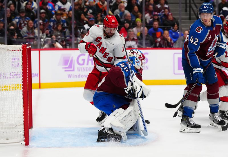 Nov 9, 2024; Denver, Colorado, USA; Carolina Hurricanes left wing William Carrier (28) shoots the puck at Colorado Avalanche goaltender Alexandar Georgiev (40) at Ball Arena. Mandatory Credit: Ron Chenoy-Imagn Images
