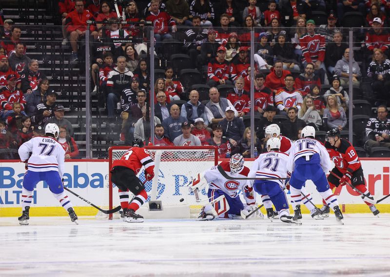 Nov 7, 2024; Newark, New Jersey, USA; New Jersey Devils left wing Jesper Bratt (63) scores a goal against the Montreal Canadiens during the first period at Prudential Center. Mandatory Credit: Ed Mulholland-Imagn Images