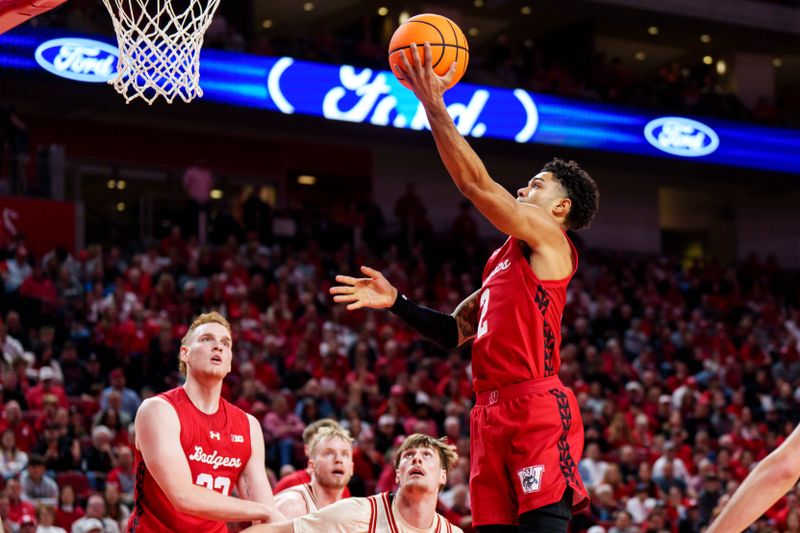Dec 10, 2025; Lincoln, Nebraska, USA; Wisconsin Badgers guard Nick Boyd (2) shoots the ball against Nebraska Cornhuskers forward Braden Frager (5) during the second half at Pinnacle Bank Arena. Mandatory Credit: Dylan Widger-Imagn Images