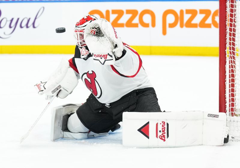 Mar 26, 2024; Toronto, Ontario, CAN; New Jersey Devils goaltender Jake Allen (34) attempts to stop the puck against the Toronto Maple Leafs during the first period at Scotiabank Arena. Mandatory Credit: Nick Turchiaro-USA TODAY Sports