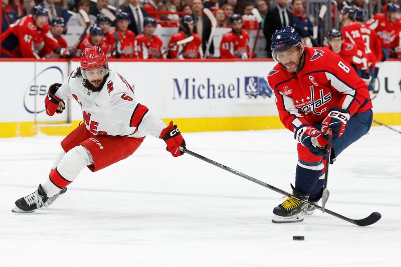 Jan 5, 2024; Washington, District of Columbia, USA; Washington Capitals left wing Alex Ovechkin (8) and Carolina Hurricanes defenseman Jalen Chatfield (5) battle for the puck d3p/ at Capital One Arena. Mandatory Credit: Geoff Burke-USA TODAY Sports