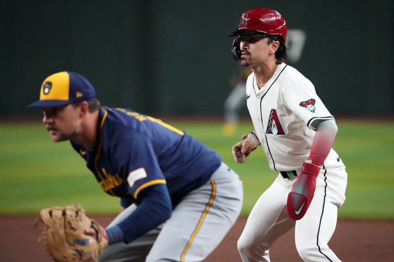 Sep 13, 2024; Phoenix, Arizona, USA; Arizona Diamondbacks outfielder Corbin Carroll (7) leads off first base as Milwaukee Brewers first base Rhys Hoskins (12) covers the bag during the first inning at Chase Field. Mandatory Credit: Joe Camporeale-Imagn Images