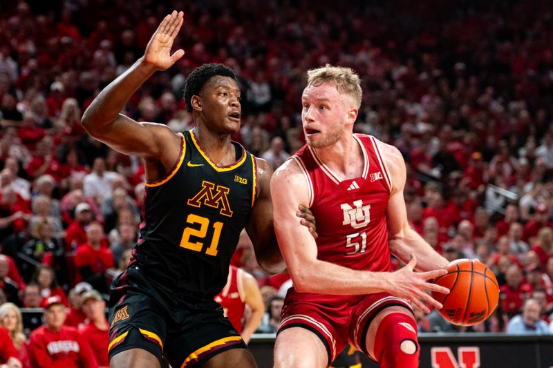 Feb 25, 2024; Lincoln, Nebraska, USA; Nebraska Cornhuskers forward Rienk Mast (51) drives against Minnesota Golden Gophers forward Pharrel Payne (21) during the first half at Pinnacle Bank Arena. Mandatory Credit: Dylan Widger-USA TODAY Sports