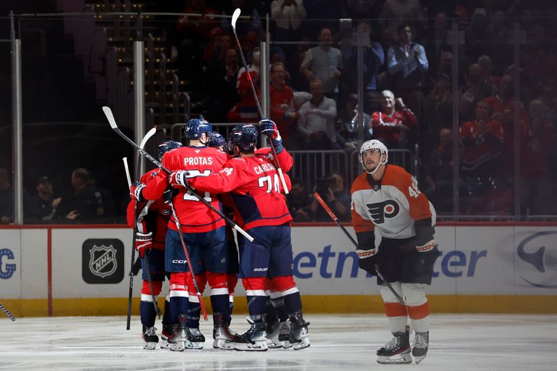 Oct 23, 2024; Washington, District of Columbia, USA; Washington Capitals center Nic Dowd (26) celebrates with teammates after scoring a goal against the Philadelphia Flyers in the second period at Capital One Arena. Mandatory Credit: Geoff Burke-Imagn Images