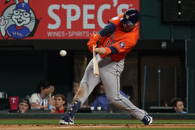 May 15, 2025; Arlington, Texas, USA; Houston Astros catcher Victor Caratini (17) hits a single during the fourth inning against the Texas Rangers at Globe Life Field. Mandatory Credit: Raymond Carlin III-Imagn Images