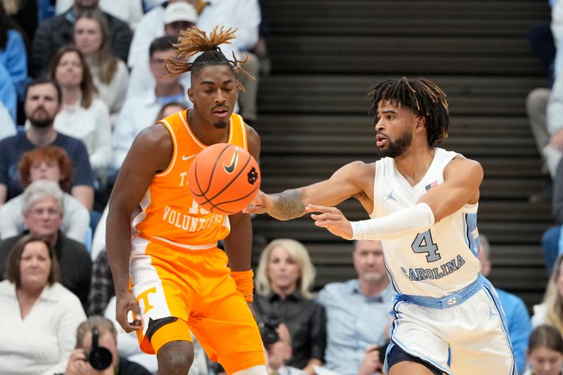 Nov 29, 2023; Chapel Hill, North Carolina, USA; North Carolina Tar Heels guard RJ Davis (4) passes the ball as Tennessee Volunteers guard Jahmai Mashack (15) defends in the first half at Dean E. Smith Center. Mandatory Credit: Bob Donnan-USA TODAY Sports