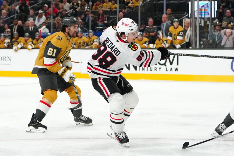 Dec 2, 2025; Las Vegas, Nevada, USA; Chicago Blackhawks center Connor Bedard (98) scores on a shot against the Vegas Golden Knights during the third period at T-Mobile Arena. Mandatory Credit: Stephen R. Sylvanie-Imagn Images