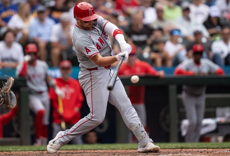 Jul 24, 2024; Seattle, Washington, USA;  Los Angeles Angels second baseman Brandon Drury (23) hits an RBI-single during the eighth inning against the Seattle Mariners at T-Mobile Park. Mandatory Credit: Stephen Brashear-USA TODAY Sports