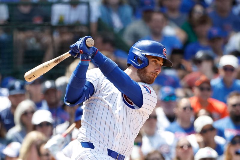 Jun 2, 2024; Chicago, Illinois, USA; Chicago Cubs outfielder Cody Bellinger (24) hits an RBI single against the Cincinnati Reds during the fifth inning at Wrigley Field. Mandatory Credit: Kamil Krzaczynski-USA TODAY Sports