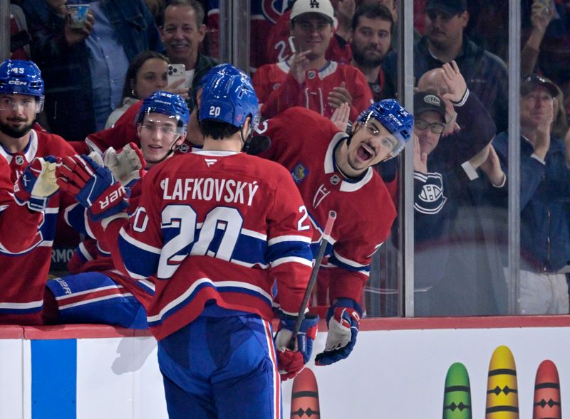 Oct 20, 2025; Montreal, Quebec, CAN; Montreal Canadiens forward Juraj Slafkovsky (20) celebrates with teammates including defenseman Arber Xhekaj (72) after scoring a goal against the Buffalo Sabres during the third period at the Bell Centre. Mandatory Credit: Eric Bolte-Imagn Images