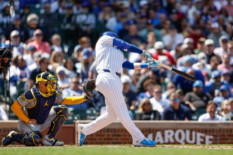 May 3, 2024; Chicago, Illinois, USA; Chicago Cubs outfielder Ian Happ (8) singles against the Milwaukee Brewers during the fourth inning at Wrigley Field. Mandatory Credit: Kamil Krzaczynski-USA TODAY Sports