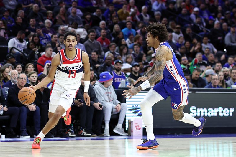 PHILADELPHIA, PENNSYLVANIA - DECEMBER 11: Jordan Poole #13 of the Washington Wizards drives past Kelly Oubre Jr. #9 of the Philadelphia 76ers during the first quarter  at the Wells Fargo Center on December 11, 2023 in Philadelphia, Pennsylvania. (Photo by Tim Nwachukwu/Getty Images)