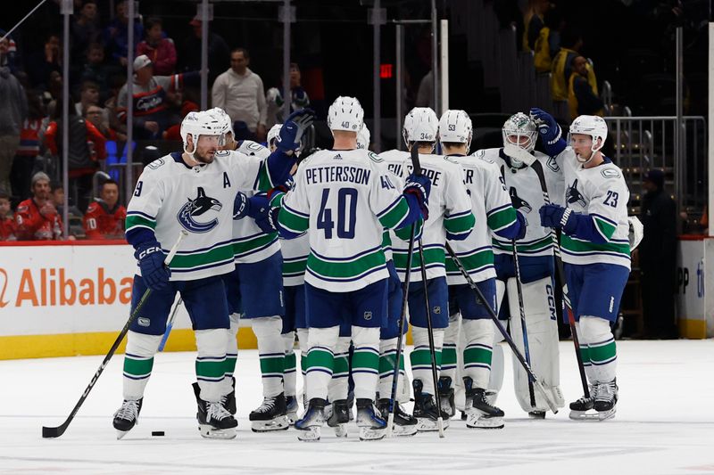 Feb 11, 2024; Washington, District of Columbia, USA; Vancouver Canucks goaltender Thatcher Demko (35) celebrates with teammates after their game against the Washington Capitals at Capital One Arena. Mandatory Credit: Geoff Burke-USA TODAY Sports