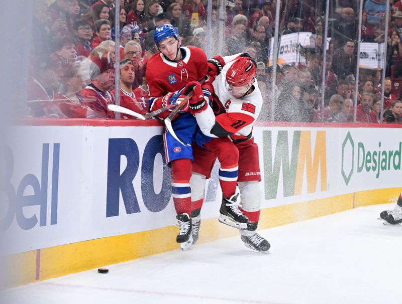 Mar 24, 2026; Montreal, Quebec, CAN; Carolina Hurricanes forward Jordan Staal (11) checks Montreal Canadiens defenseman Lane Hutson (48) during the first period at the Bell Centre. Mandatory Credit: Eric Bolte-Imagn Images