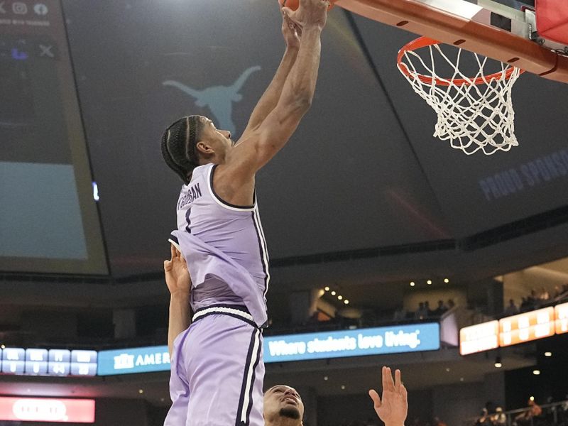 Feb 19, 2024; Austin, Texas, USA; Kansas State Wildcats forward David N'Guessan (1) goes up to dunk over Texas Longhorns forward Dylan Disu (1) during the second half at Moody Center. Mandatory Credit: Scott Wachter-USA TODAY Sports