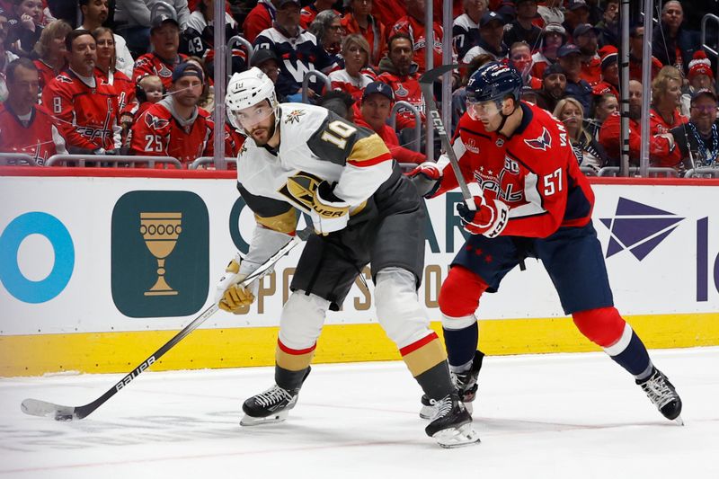 Oct 15, 2024; Washington, District of Columbia, USA; Vegas Golden Knights center Nicolas Roy (10) skates with the puck as Washington Capitals defenseman Trevor van Riemsdyk (57) defends in the second period at Capital One Arena. Mandatory Credit: Geoff Burke-Imagn Images