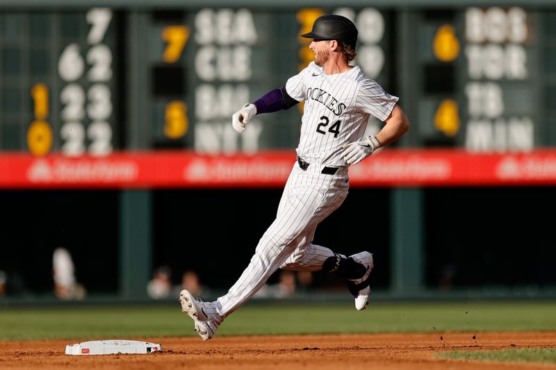 Jun 18, 2024; Denver, Colorado, USA; Colorado Rockies third baseman Ryan McMahon (24) reaches second on a two RBI double in the first inning against the Los Angeles Dodgers at Coors Field. Mandatory Credit: Isaiah J. Downing-USA TODAY Sports