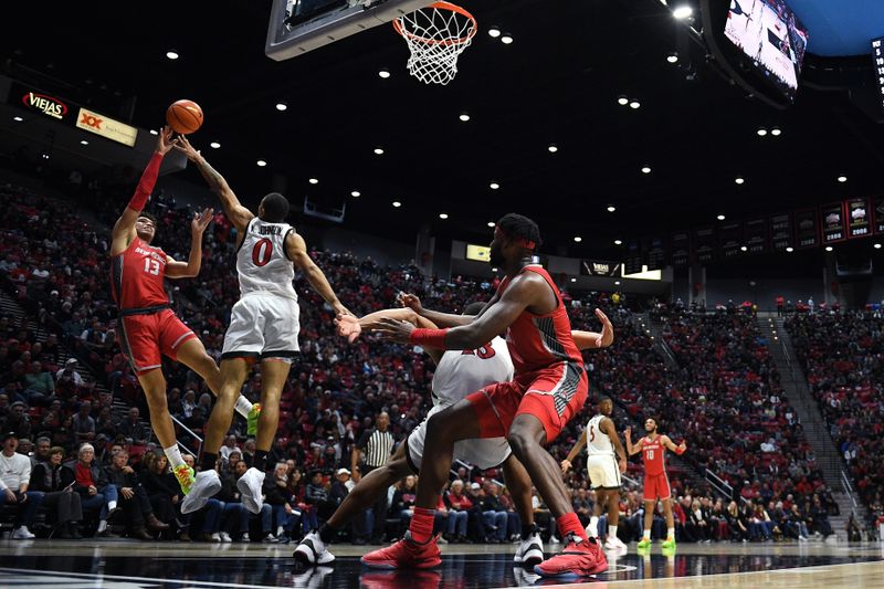 Jan 14, 2023; San Diego, California, USA; New Mexico Lobos guard Javonte Johnson (13) shoots the ball over San Diego State Aztecs forward Keshad Johnson (0) during the second half at Viejas Arena. Mandatory Credit: Orlando Ramirez-USA TODAY Sports