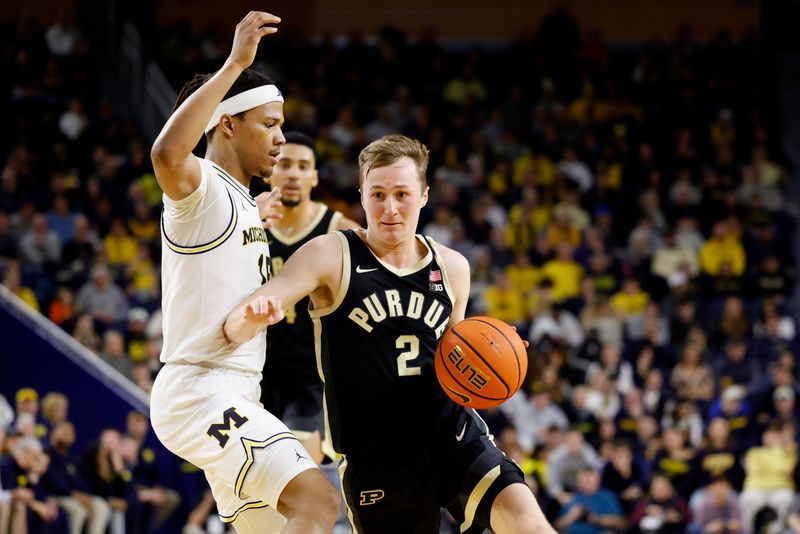 Feb 11, 2025; Ann Arbor, Michigan, USA;  Purdue Boilermakers guard Fletcher Loyer (2) dribbles on Michigan Wolverines guard Rubin Jones (15) in the second half at Crisler Center. Mandatory Credit: Rick Osentoski-Imagn Images