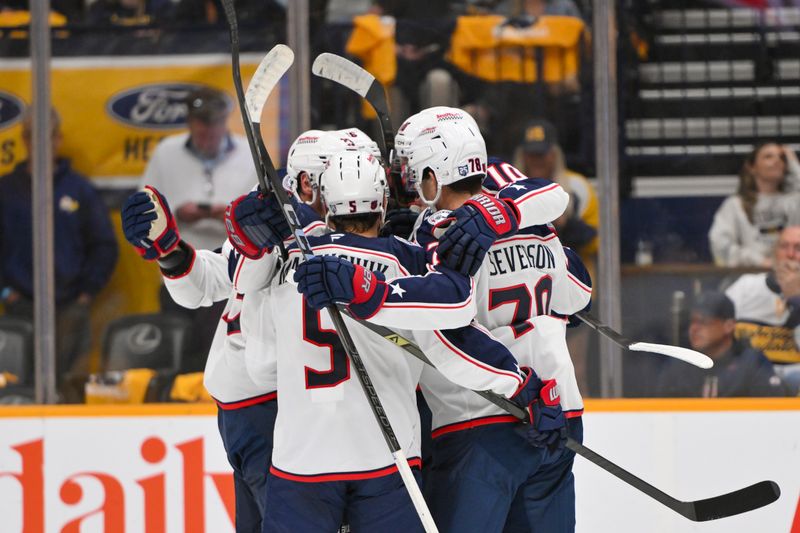 Oct 9, 2025; Nashville, Tennessee, USA; Columbus Blue Jackets left wing Dmitri Voronkov (10) celebrates with his teammates after scoring a goal against the Nashville Predators during the first period at Bridgestone Arena. Mandatory Credit: Steve Roberts-Imagn Images