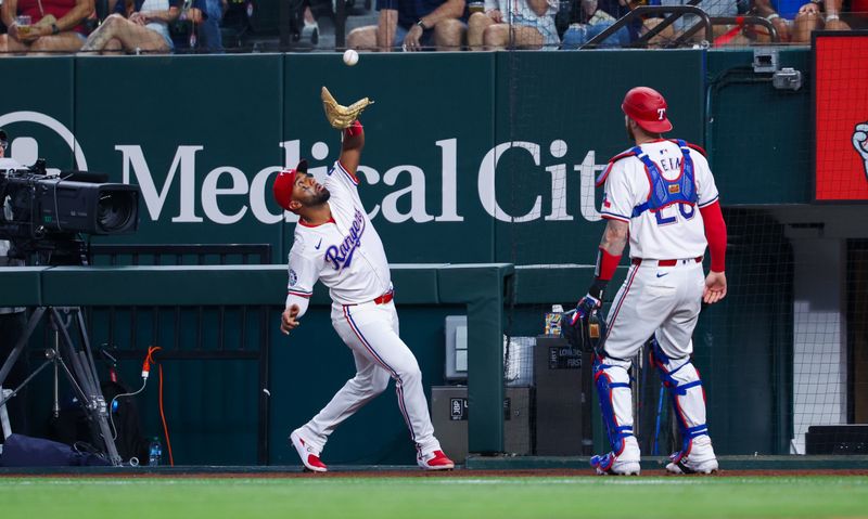 Aug 6, 2024; Arlington, Texas, USA; Texas Rangers first baseman Ezequiel Duran (20) makes a catch during the sixth inning against the Houston Astros at Globe Life Field. Mandatory Credit: Kevin Jairaj-USA TODAY Sports